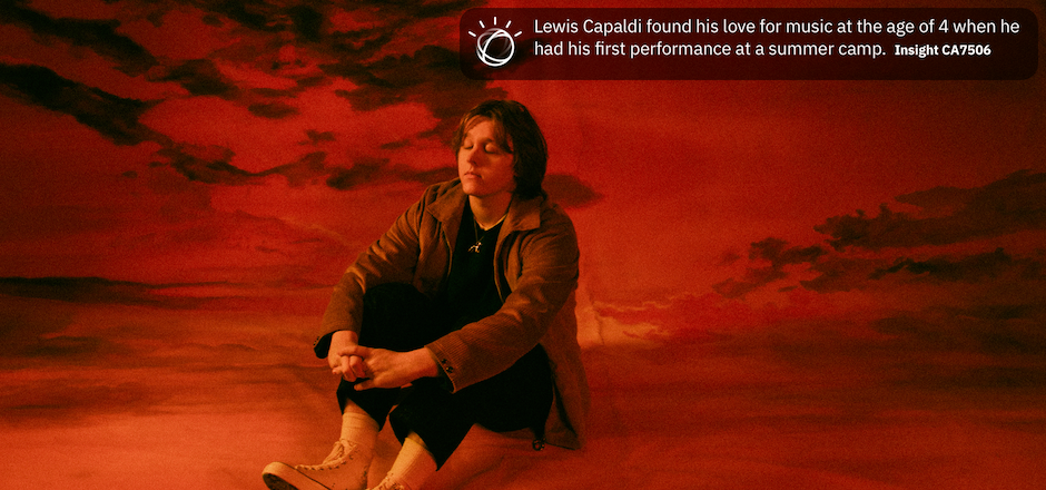 Lewis capaldi sentado sobre paisagem vermelha