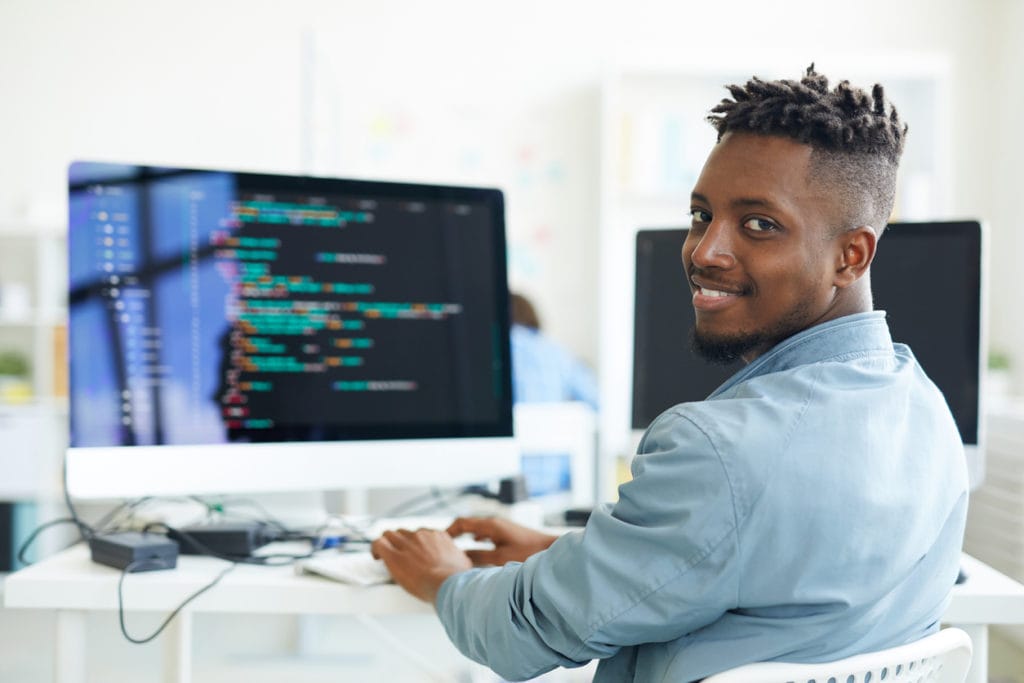 A young black man takes a professional technology course