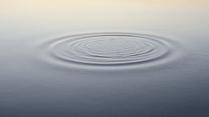 Imagem de ondas geradas pela ação de uma pedra caindo na água.