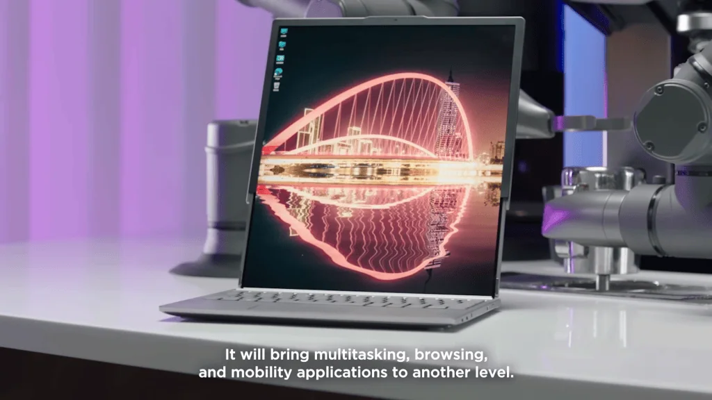 모토로라, 롤업 스크린 휴대전화 콘셉트 선보여 테이블 위에 롤업 화면이 확장된 노트북