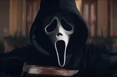 Cena do vilão "ghostface" em "pânico 6". O personagem está próximo da câmera, segurando uma faca.