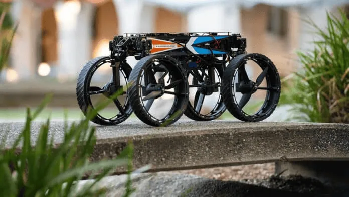 Drone transformer, com rodas, é capaz de voar e andar Drone m4 t alt robô apoiado com as quatro rodas sob superfície, com folhas no canto inferior à esq.