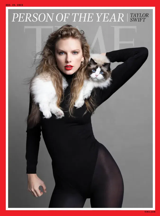 En svartvit katt som sitter på axeln av en kvinna med lockigt hår och svart klänning finns på omslaget till tidningen Time.