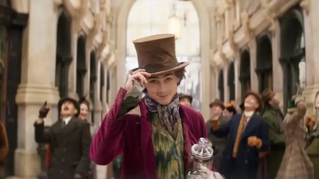 Homem vestido como willy wonka em fantasia de filme clássico em rua histórica brasileira.