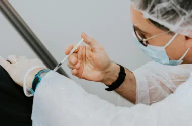 Vaccine being administered to a patient, immunization technique, healthcare professional, disease prevention.