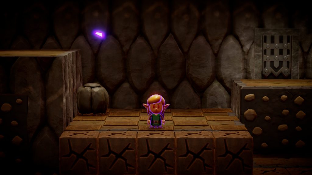 Imagem de personagem de the legend of zelda no jogo nintendo, em cenário de dungeon com blocos e parede de pedra.