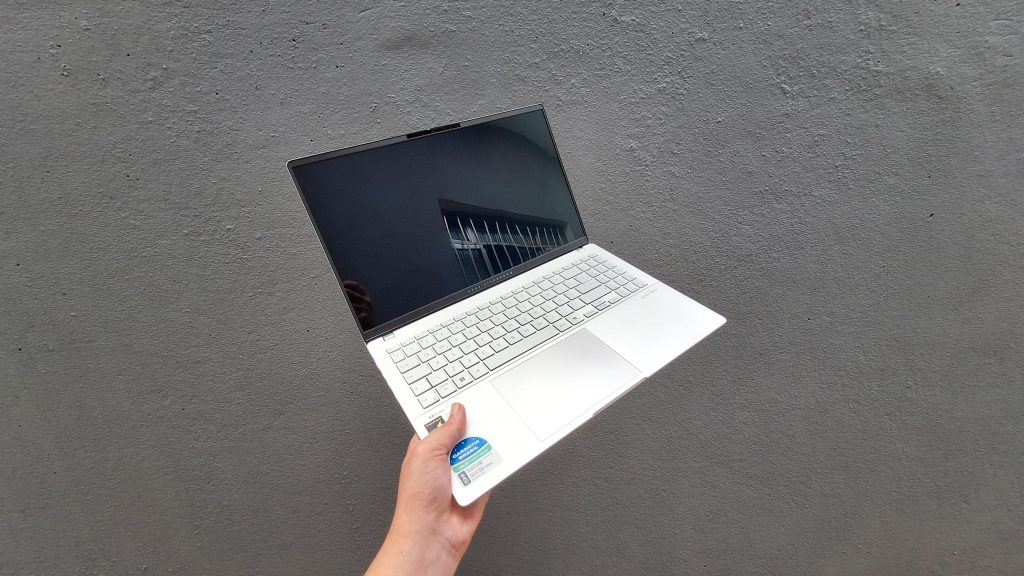 Test : l'asus vivobook s 15 est excellent pour la productivité Asus vivobook s 15 sur fond gris détenu par l'homme