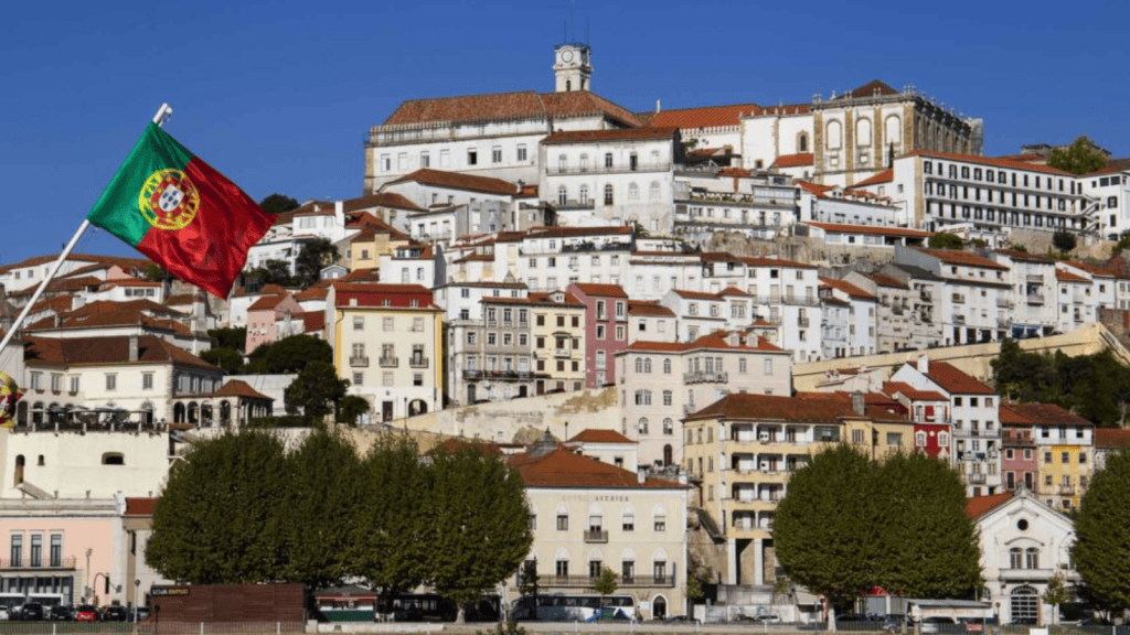Portuguese flag flying over lisbon, portugal. Iconic cityscape with historic buildings and hillside views.