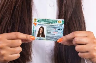 Driver's license with Brazilian document, happy citizen, vehicle document control.