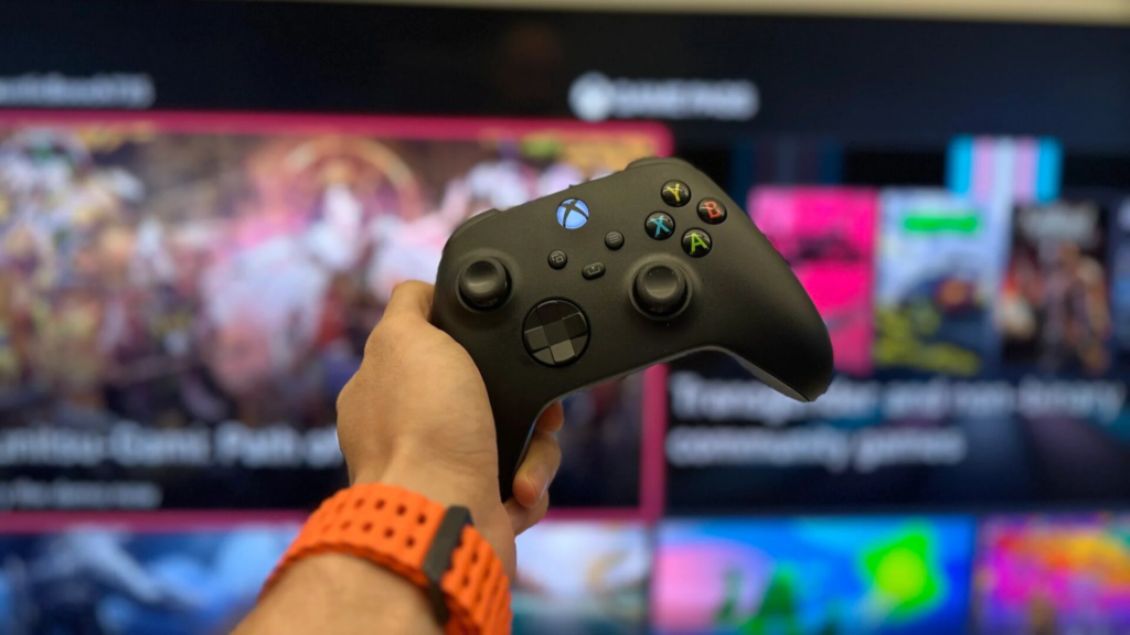 Controle do xbox segurando na frente do católogo do game pass