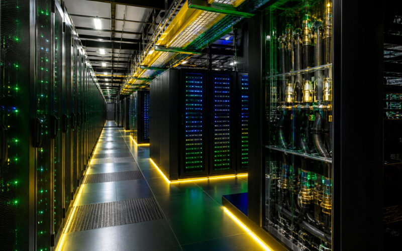 Corredor de um centro de supercomputação com racks e sistema de refrigeração